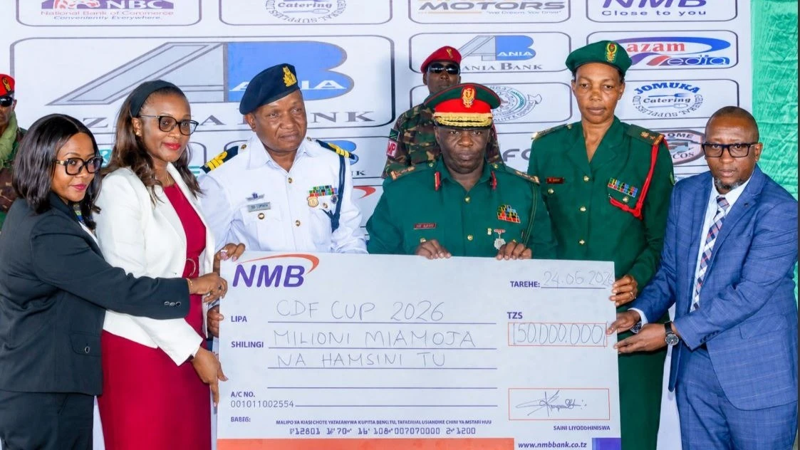 NMB Bank Head of Personal Banking Aikansia Muro (left) presents a dummy cheque representing the bank’s TZS 150 million sponsorship to CDF Cup 2026 Organising Committee Chairperson Brigadier General Saidi Hamis Saidi in Dar es Salaam.