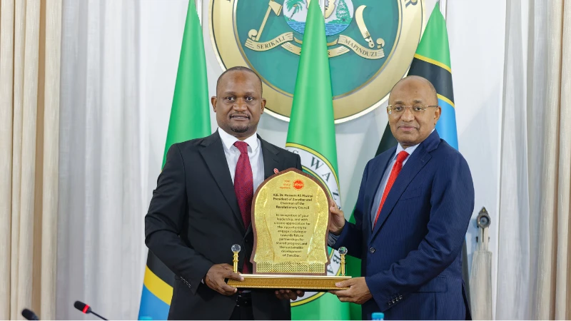 Absa Bank Tanzania Managing Director, Mr. Obedi Laiser (left), presents a token of appreciation to Dr. Hussein Ali Mwinyi, President of Zanzibar and Chairman of the Revolutionary Council, in recognition of the strong partnership