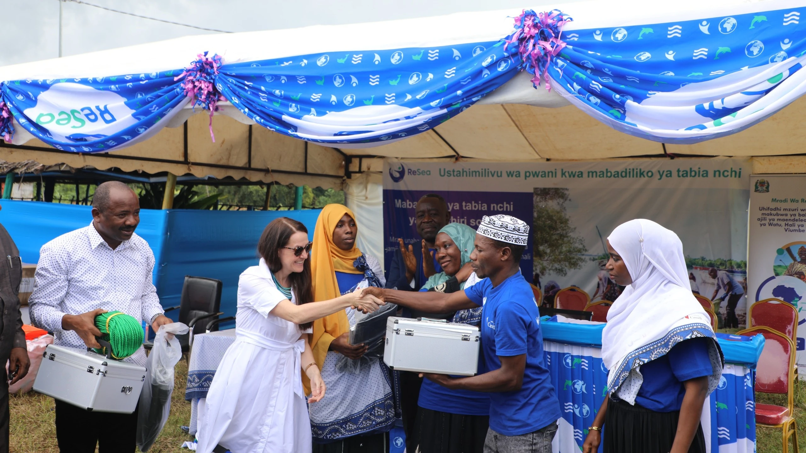 Hamsi Othman of the Tujiongeee Group in Mkoani, Pemba, receives a first aid kit on behalf of the group from Emily Burns, High Commissioner of Canada to Tanzania, during the equipment handover ceremony. Photo: Courtesy of the High Commission of Canada.