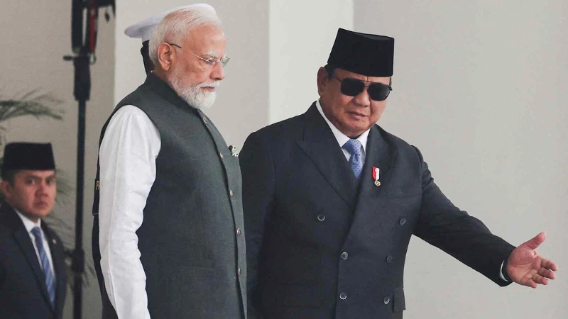 Indonesian President Prabowo Subianto shows the way to Indian Prime Minister Narendra Modi during a welcoming ceremony ahead of their meeting at the Merdeka Palace in Jakarta on July 7.